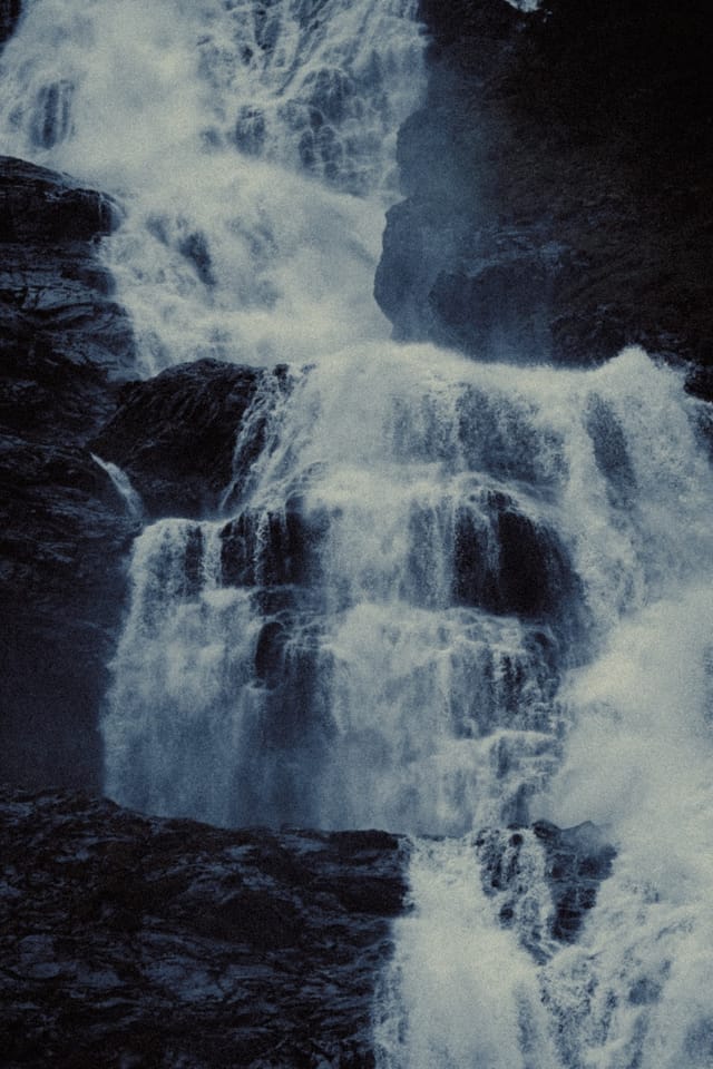 Tiered white water cascading over dark Norwegian rock